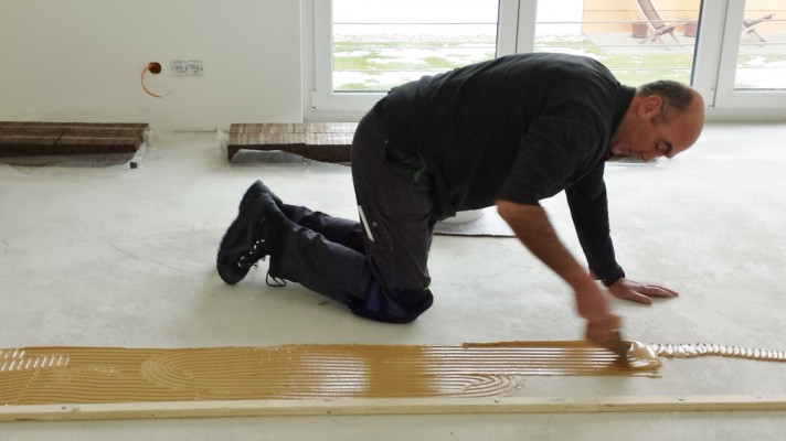 tadjali schreinermeister münchen vollholztisch massanfertigung einbauküche hochwertige geräte siemens miele grohe bora edles desig dunkles holz esstisch küche küchentisch komplettausbau extra angefertigt sorgfältige arbeit ppräzision schreiner münchen handwerk design milberg der nette schreiner parkettboden vorbereitung kleber verteilen